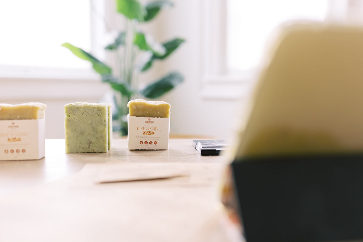 Three bars of soap on a table with a blurred background